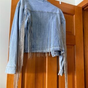 This is a unique, jean jacket embellished with crystals down the back